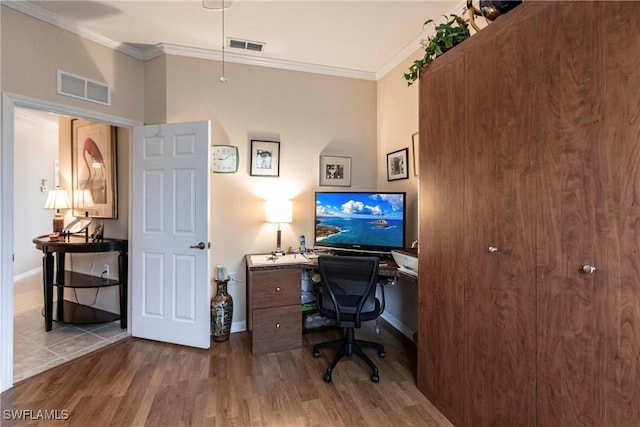 home office featuring wood-type flooring and crown molding