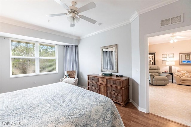 bedroom featuring ceiling fan, hardwood / wood-style flooring, and crown molding