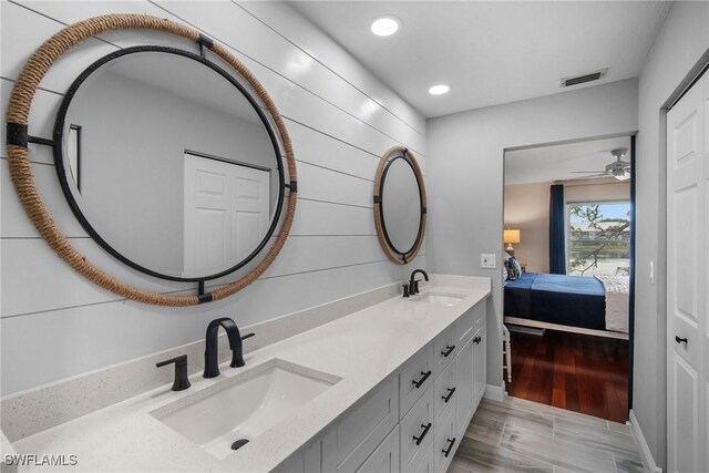 bathroom with vanity, hardwood / wood-style floors, and ceiling fan