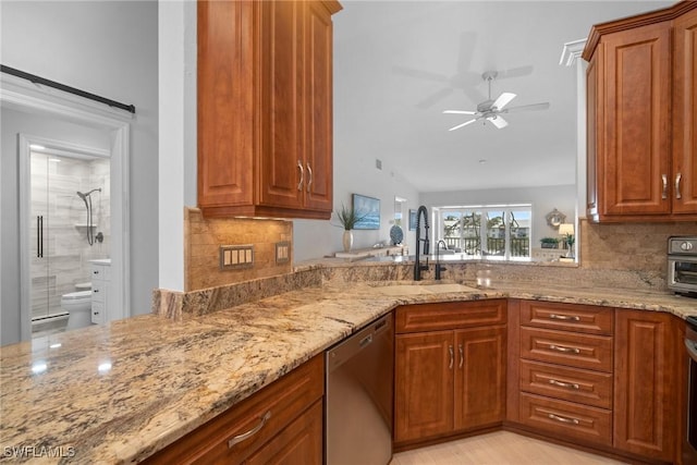 kitchen featuring dishwasher, sink, decorative backsplash, ceiling fan, and light stone counters