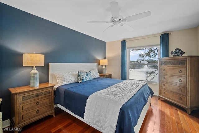 bedroom featuring ceiling fan and dark hardwood / wood-style flooring