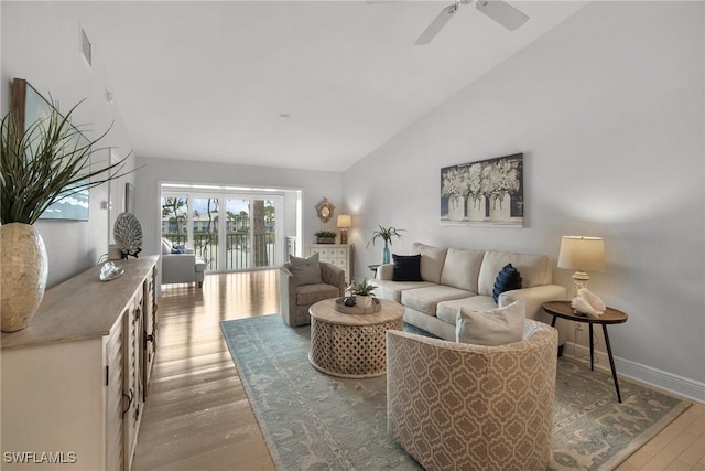 living room featuring ceiling fan, hardwood / wood-style floors, and high vaulted ceiling