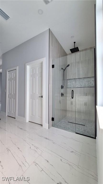 bathroom with a shower with shower door