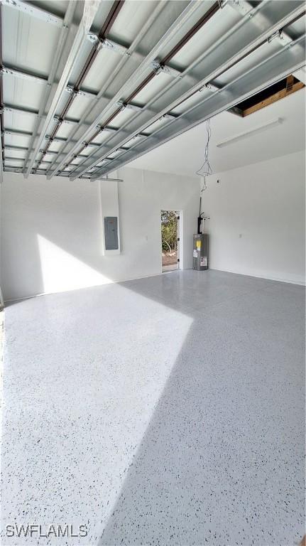 garage featuring water heater and electric panel