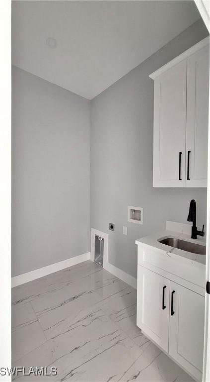 laundry room featuring sink, hookup for an electric dryer, hookup for a washing machine, and cabinets