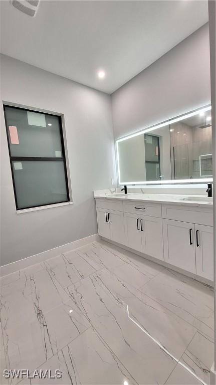 full bathroom featuring recessed lighting, a sink, baseboards, marble finish floor, and double vanity