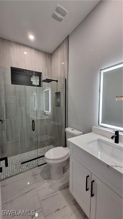 full bathroom with toilet, vanity, visible vents, marble finish floor, and a shower stall