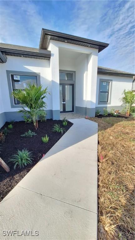 doorway to property with stucco siding