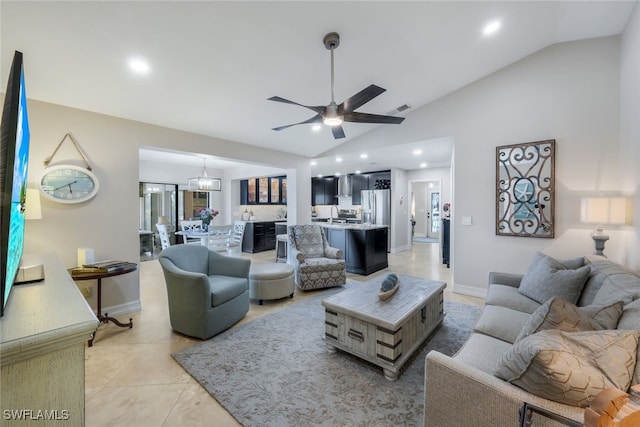 tiled living room featuring ceiling fan with notable chandelier and vaulted ceiling