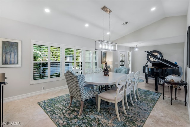 dining space featuring vaulted ceiling