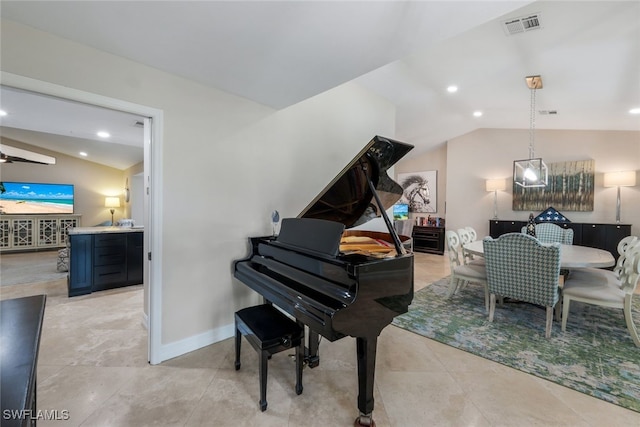 miscellaneous room featuring light tile patterned floors and vaulted ceiling