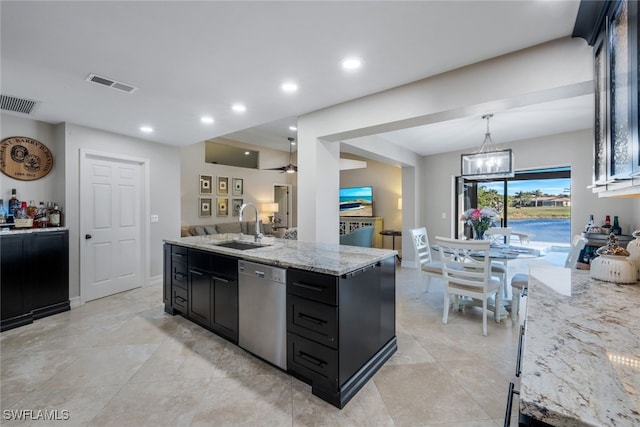 kitchen with pendant lighting, sink, a kitchen island with sink, light stone counters, and stainless steel dishwasher