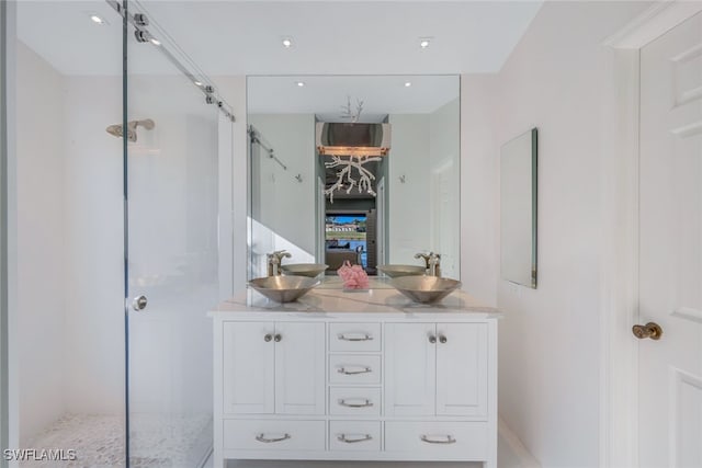 bathroom featuring vanity and an enclosed shower