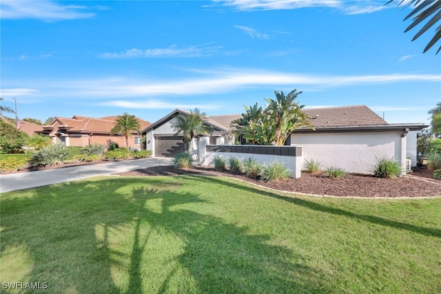 ranch-style house featuring a garage and a front yard