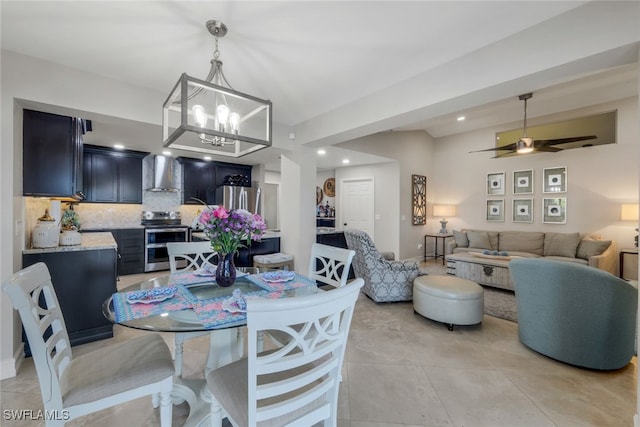 tiled dining room featuring ceiling fan with notable chandelier