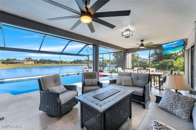 view of patio with a water view, ceiling fan, an outdoor living space, and a lanai