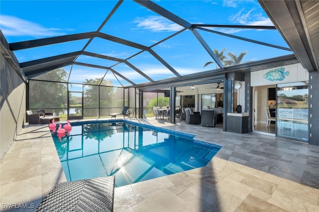 view of pool featuring an outdoor hangout area, a patio area, ceiling fan, and glass enclosure