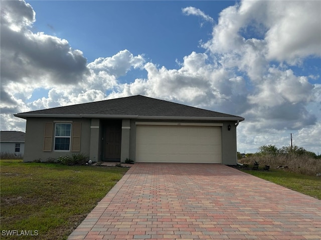 view of front of home with a front lawn and a garage