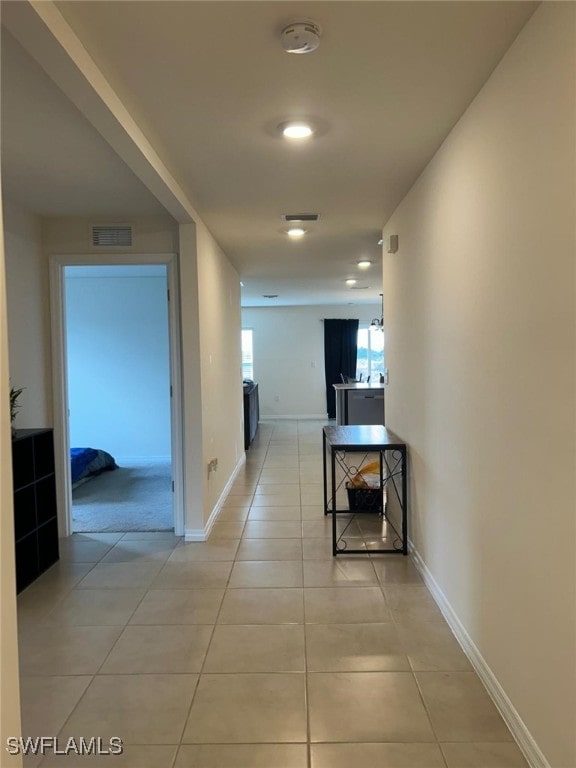 hall with light tile patterned floors