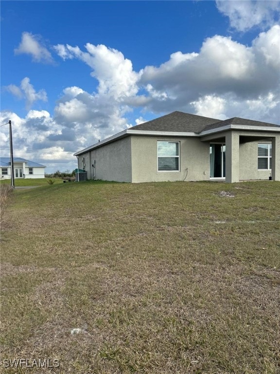 view of side of property with a lawn