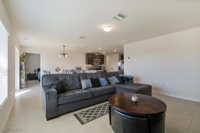 living room with light tile patterned floors and a chandelier