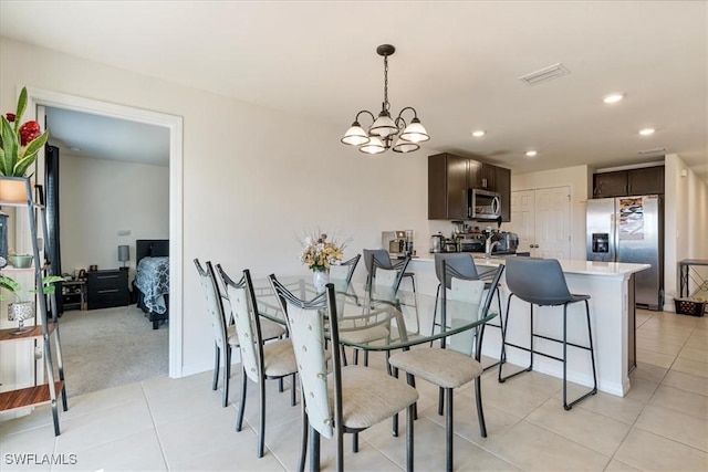 dining space with a notable chandelier and light tile patterned flooring