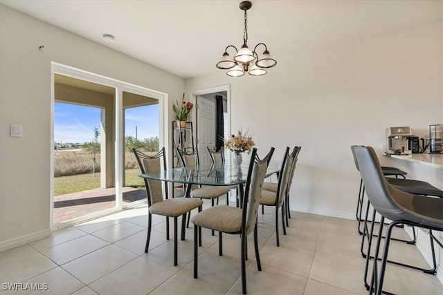 tiled dining space featuring a notable chandelier