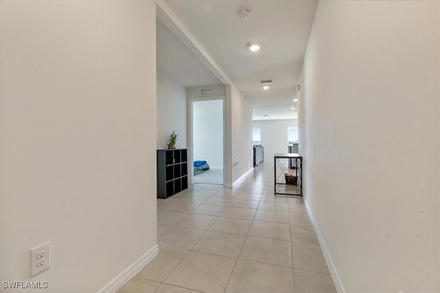 hallway featuring light tile patterned floors