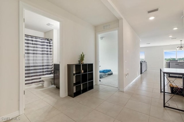 hallway with light tile patterned floors