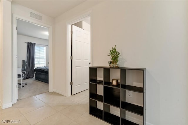 corridor featuring light tile patterned floors