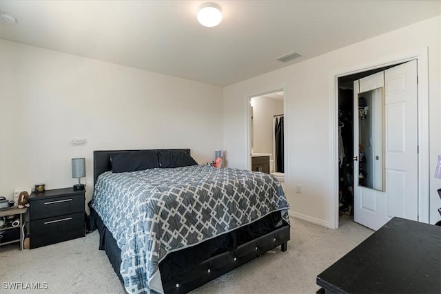 bedroom with light colored carpet and a closet