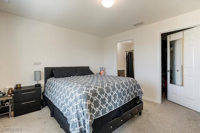 carpeted bedroom featuring a spacious closet and a closet