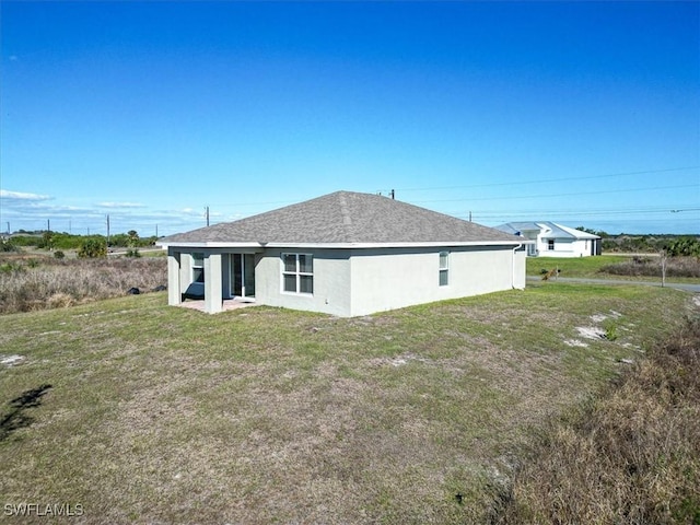 back of house featuring a lawn