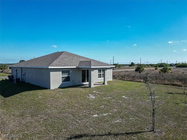 rear view of house featuring a lawn