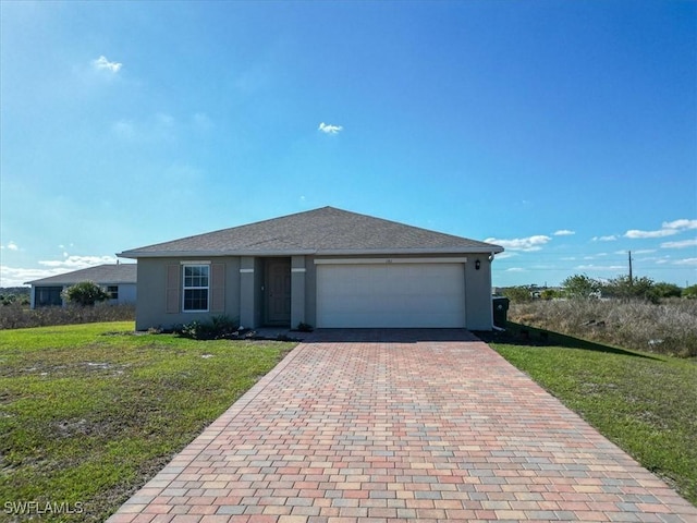 view of front of house with a garage and a front lawn