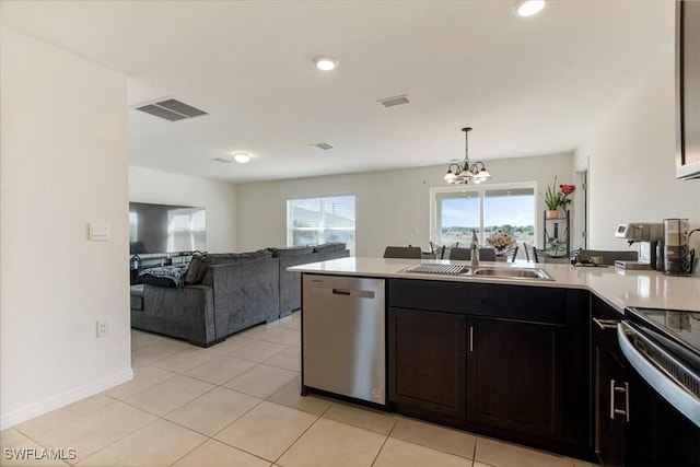 kitchen with light tile patterned flooring, sink, electric range, dishwasher, and pendant lighting