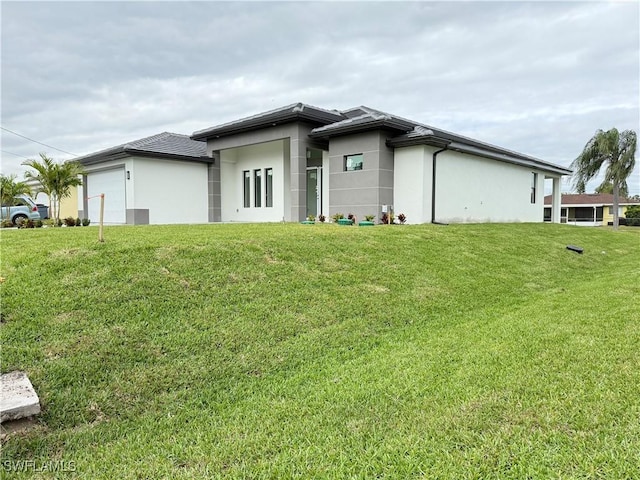 exterior space featuring a garage and a yard