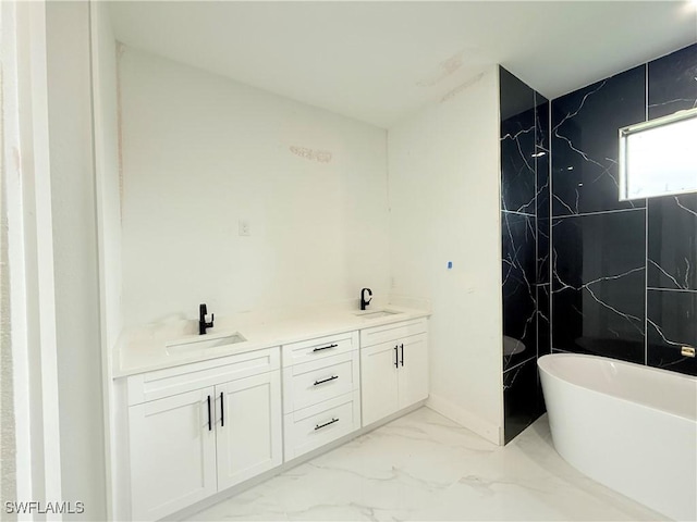 bathroom with vanity and a bath