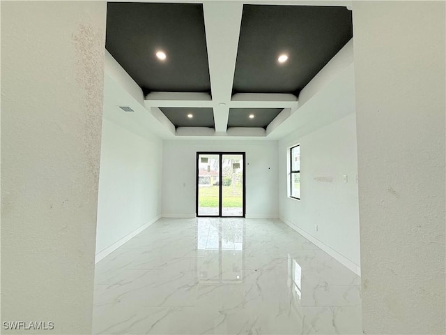 unfurnished room featuring coffered ceiling and beamed ceiling