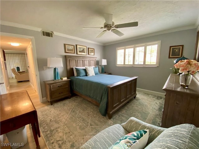 bedroom with a textured ceiling, ornamental molding, and ceiling fan