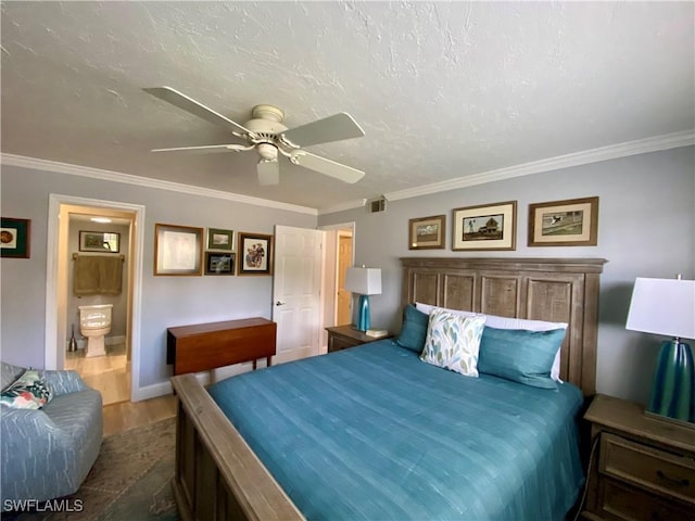 bedroom with ensuite bathroom, dark hardwood / wood-style flooring, ornamental molding, and ceiling fan