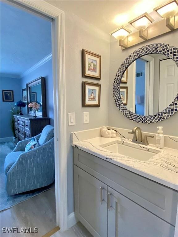 bathroom featuring crown molding and vanity