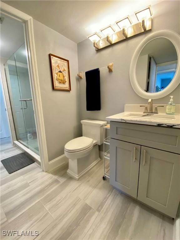 bathroom with vanity, toilet, and walk in shower