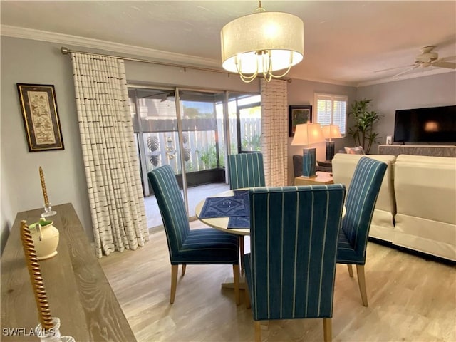 dining room with crown molding, ceiling fan, and hardwood / wood-style flooring