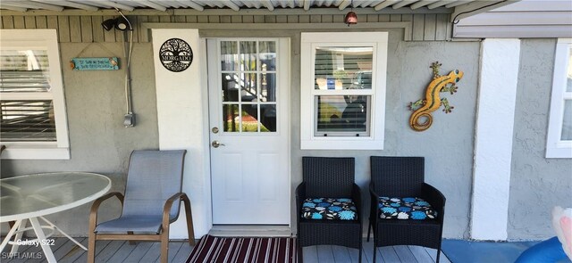 entrance to property featuring stucco siding