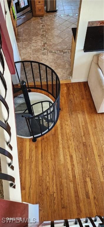 stairs featuring hardwood / wood-style flooring