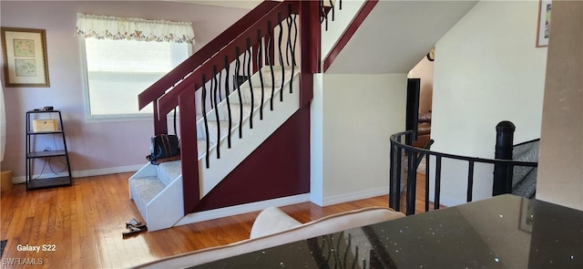 stairs featuring baseboards and wood finished floors