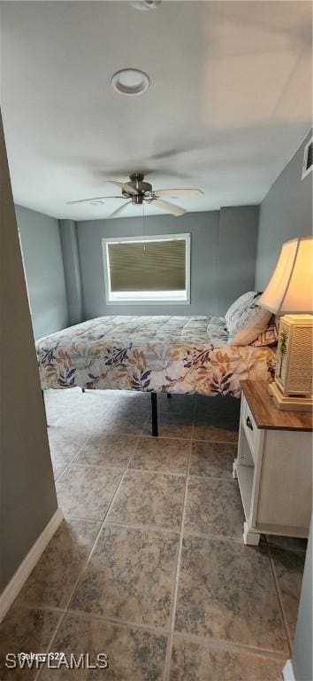 interior space with baseboards and a ceiling fan