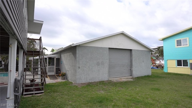 view of outbuilding featuring an outbuilding, driveway, and stairs