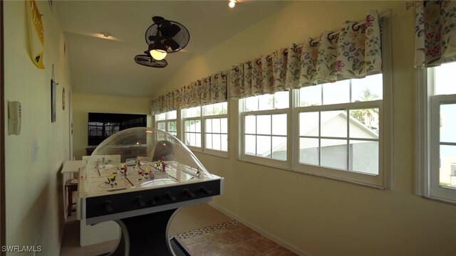 rec room featuring lofted ceiling and baseboards